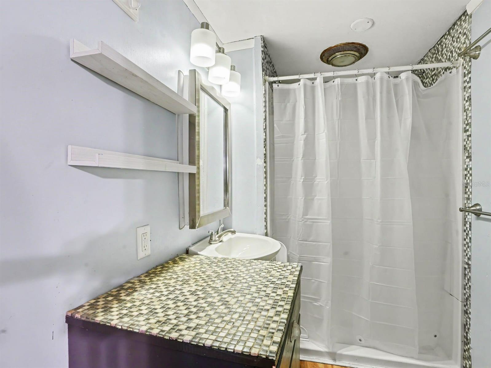Master Bath with Mosaic Tile Countertop & Frameless Shower Enclosure