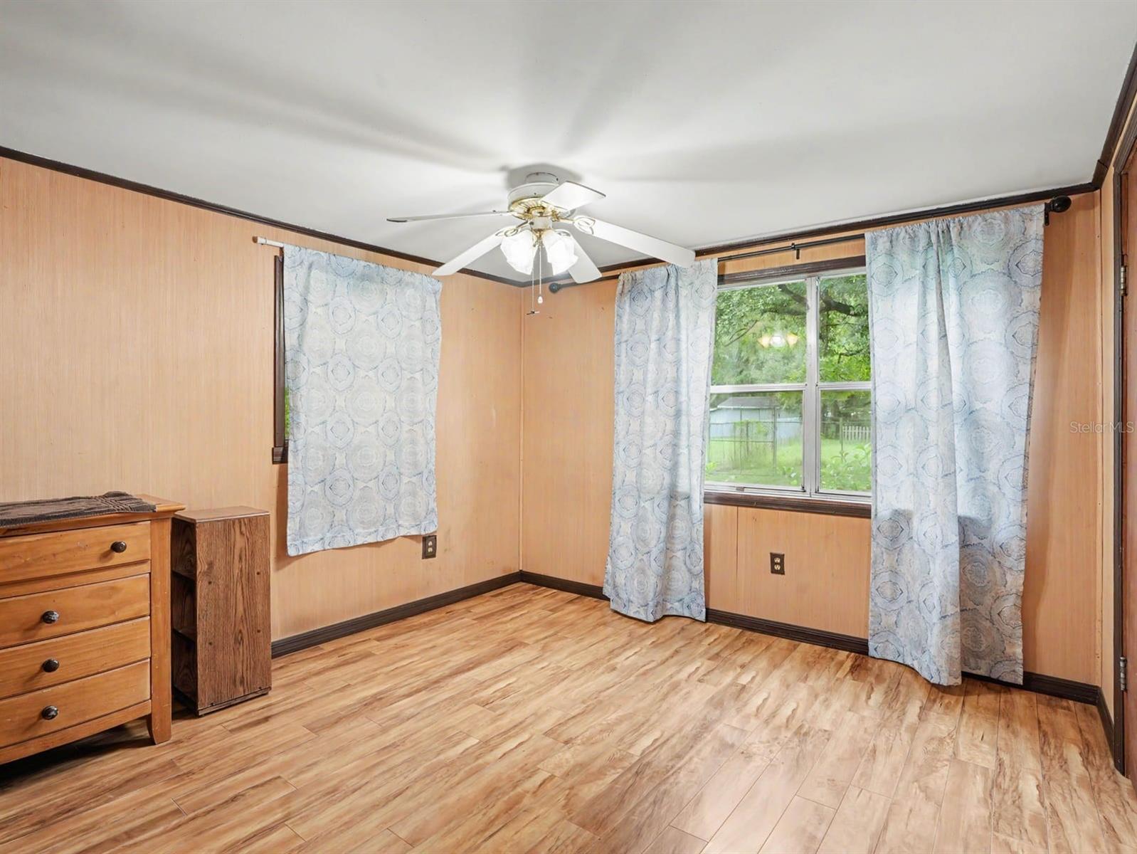Bright Master Bedroom with Ceiling Fan, Large Windows & Ample Natural Light