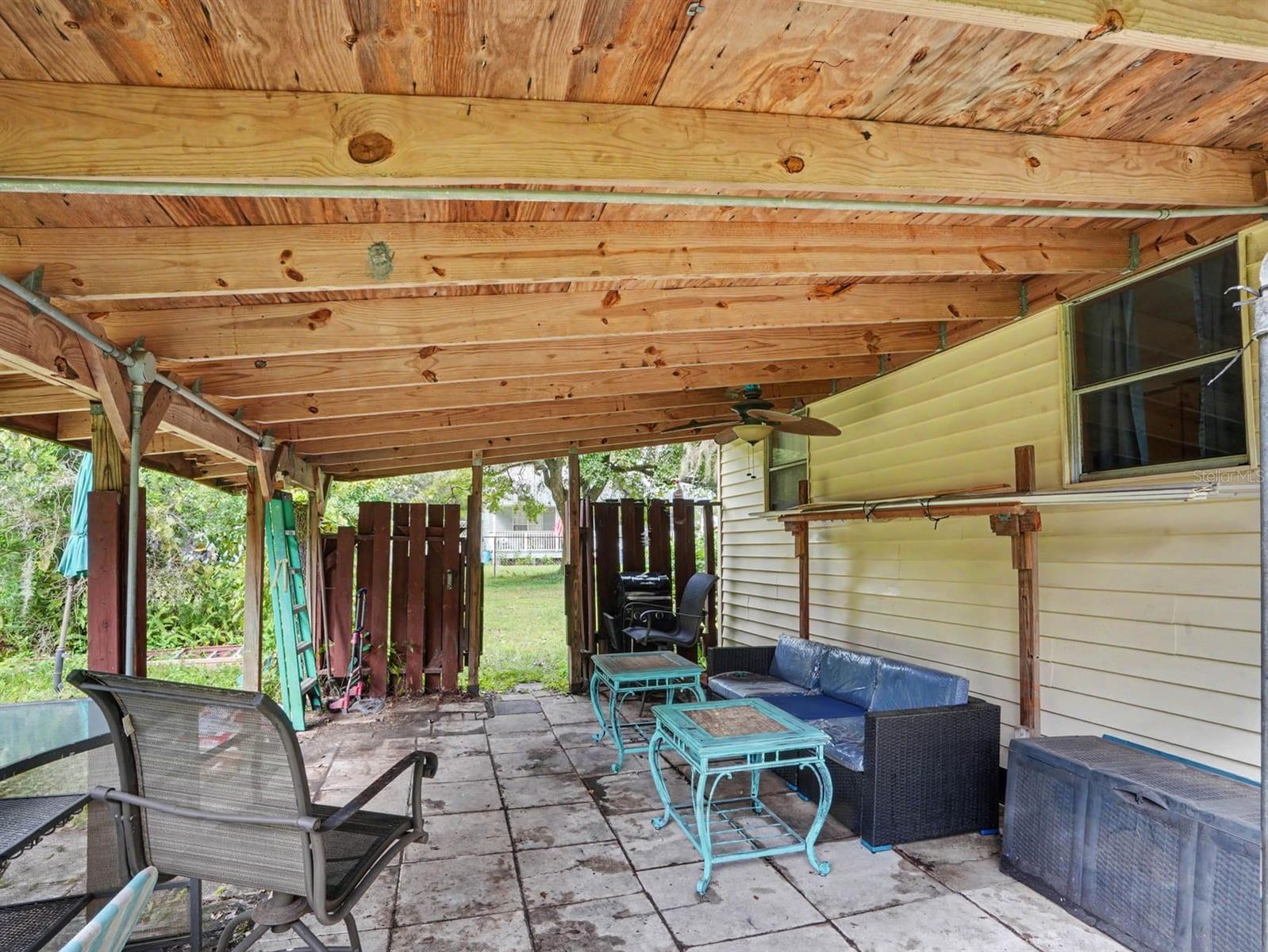 Covered Patio with Wooden Beams & Ample Seating Area
