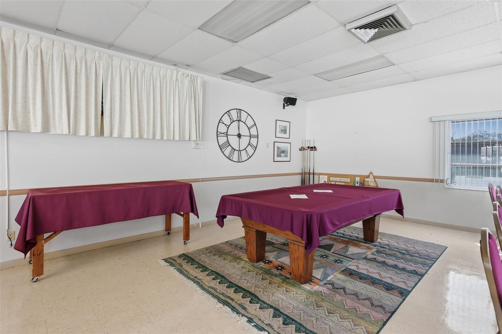 Community clubhouse recreation room with billiards table.