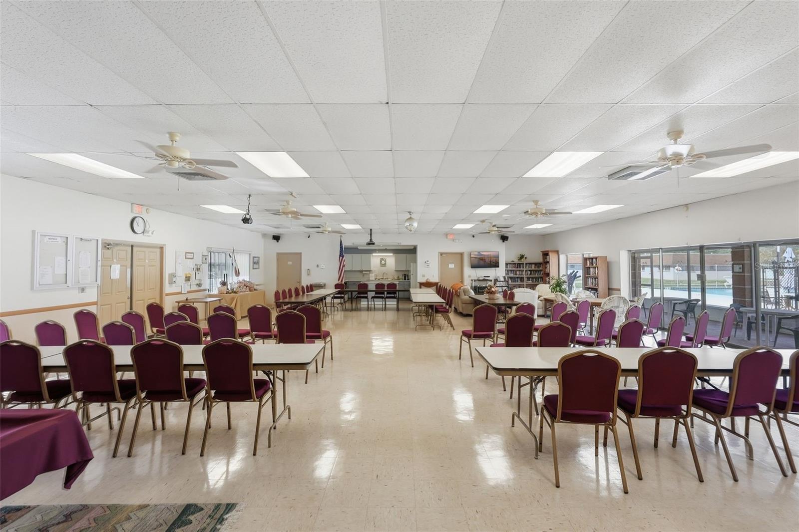 Spacious community clubhouse gathering and social activity room.