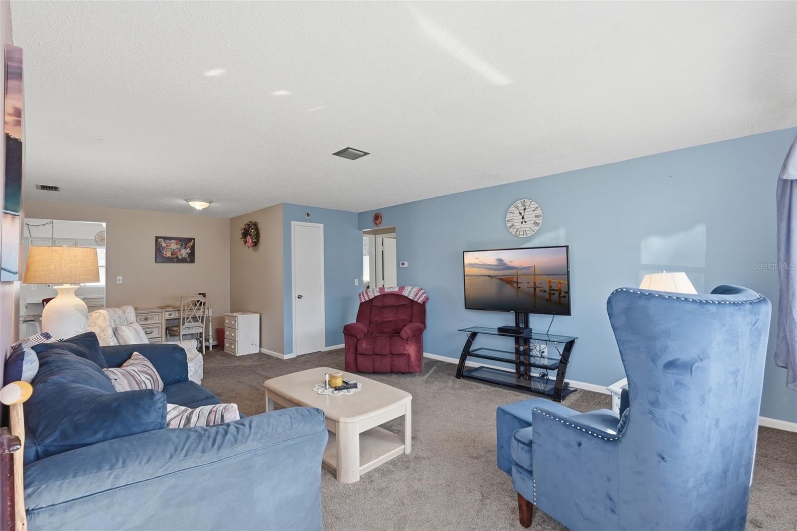 Spacious living room with comfortable seating and an open, inviting layout. Spacious living room with comfortable seating and an open, inviting layout.