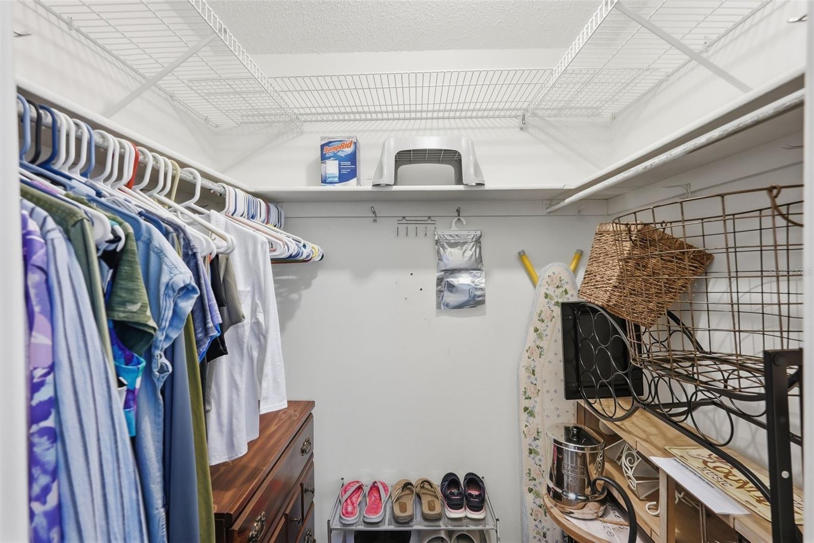 Interior closet with hanging space and shelving for organized storage.