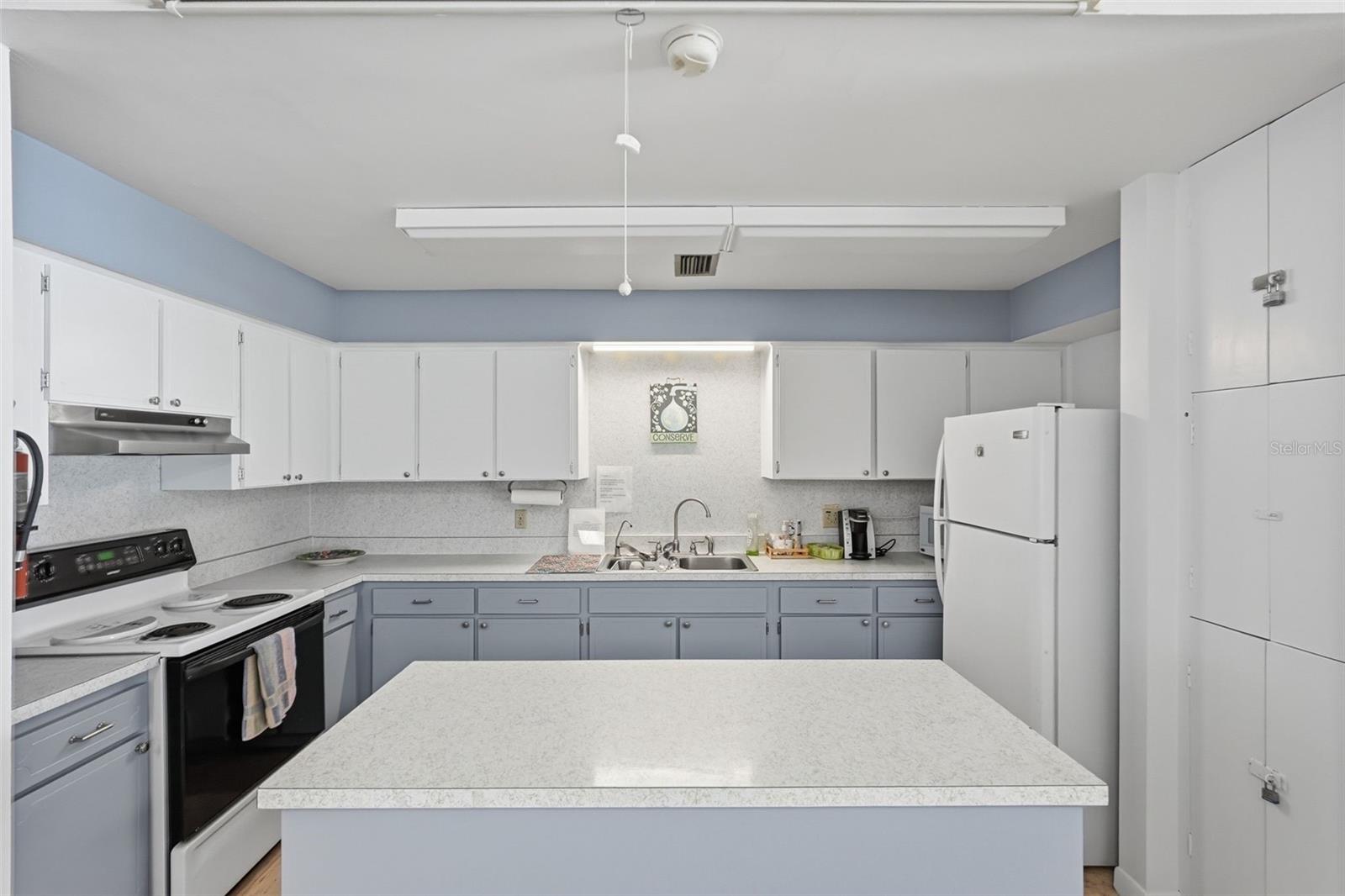 Community clubhouse kitchen for resident gatherings and activities.