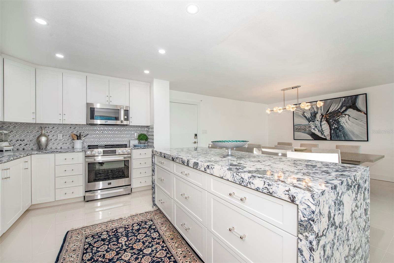 Kitchen has an open layout and center island with buffet seating for four... Kitchen has an open layout and center island with buffet seating for four...