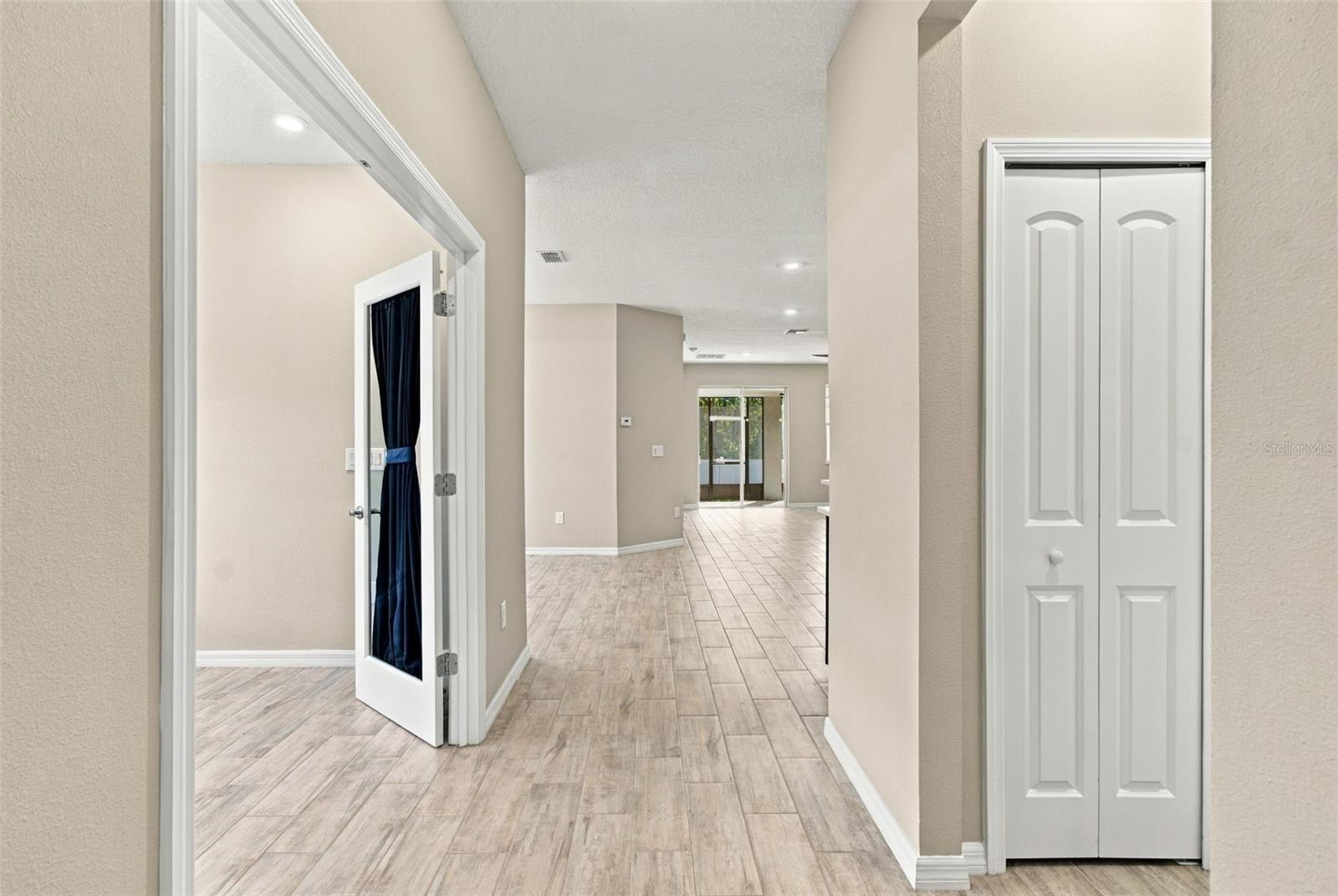 Coat closet to the right, office to the left, facing living and dining rooms