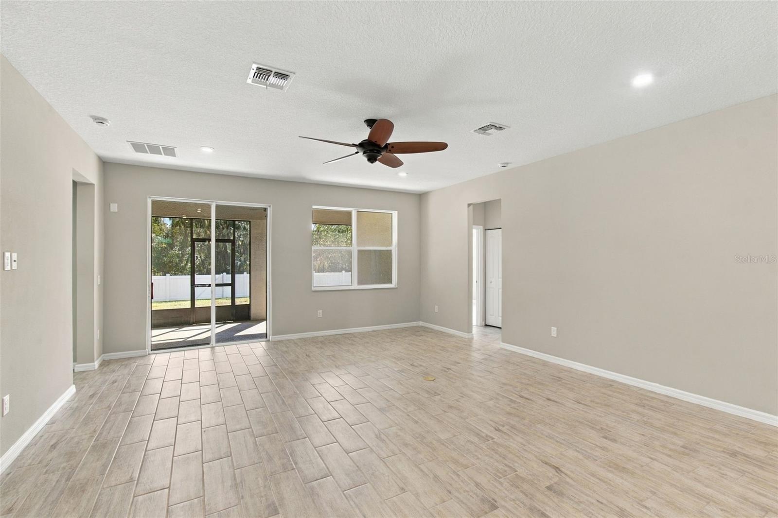 Return to Living Room, facing patio and backyard, heading towards Bedrooms to the right