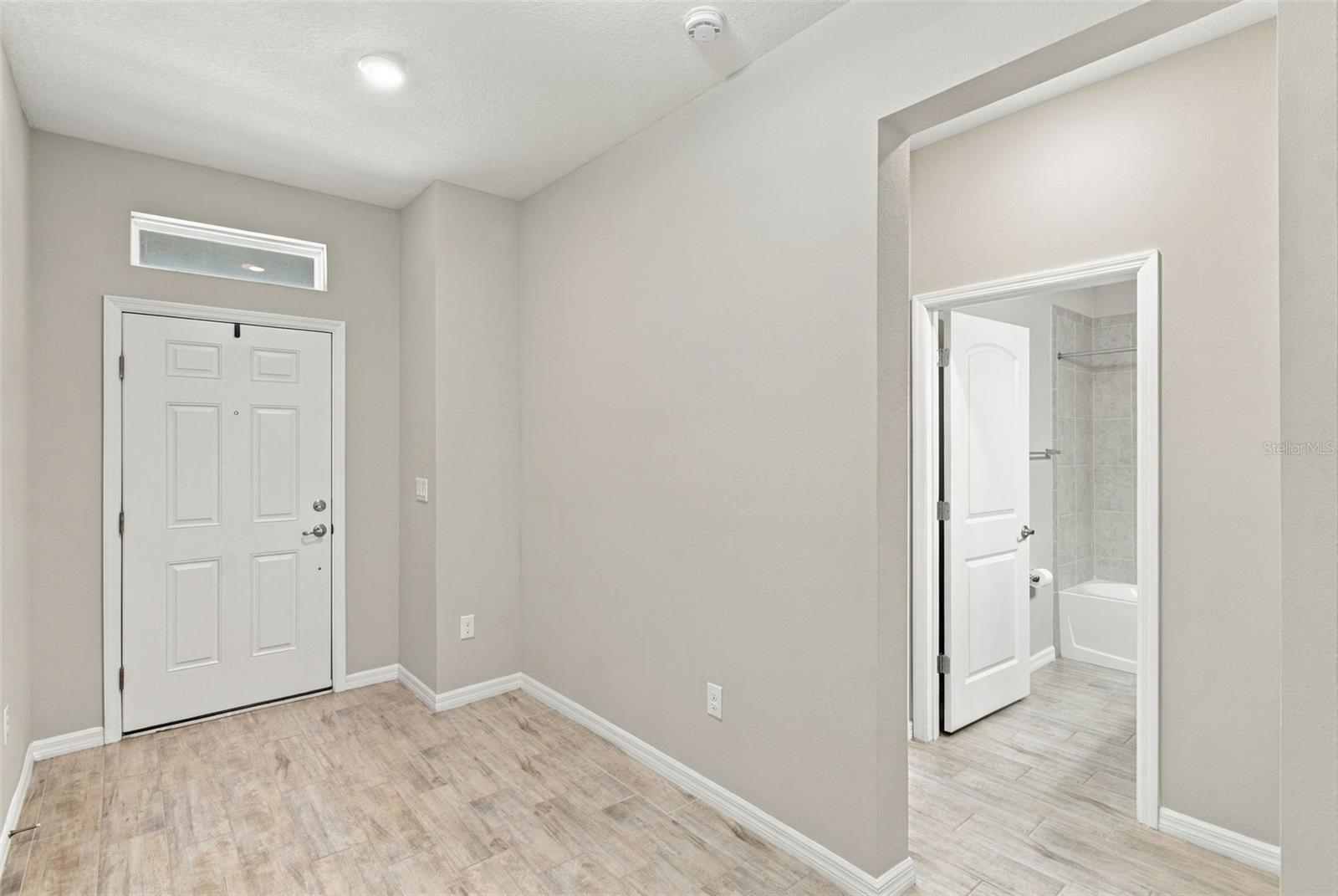 Front Door to the left, hall to enter Guest Suite on the right