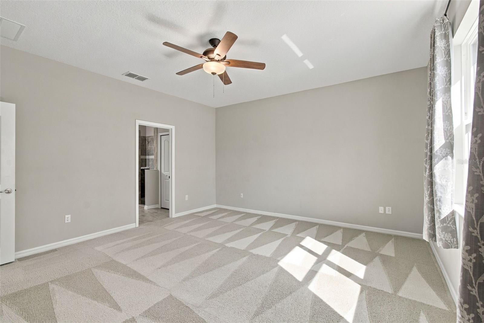 Primary bedroom with ceiling fan