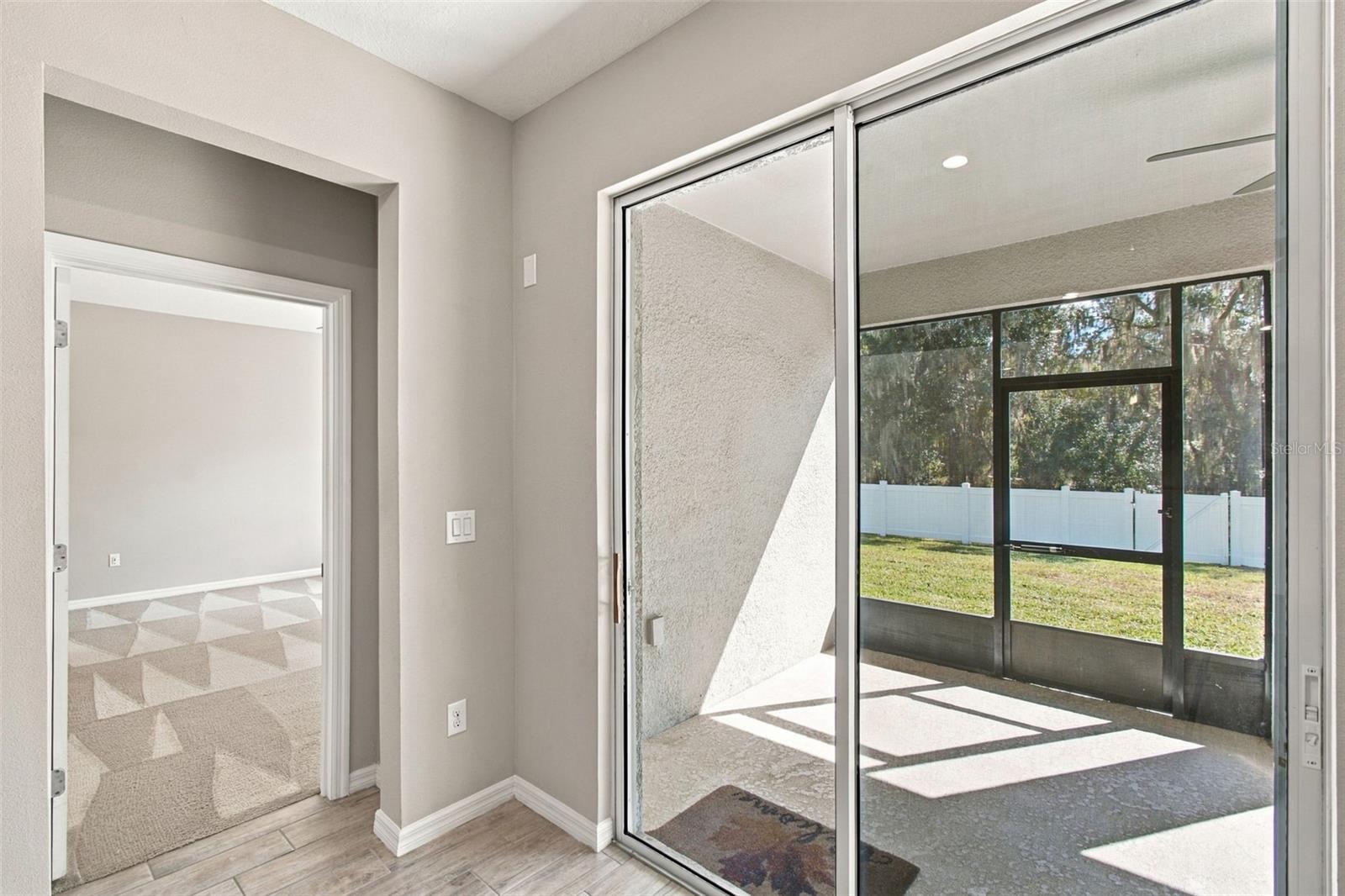 Primary Suite entrance to left, screened in patio to right