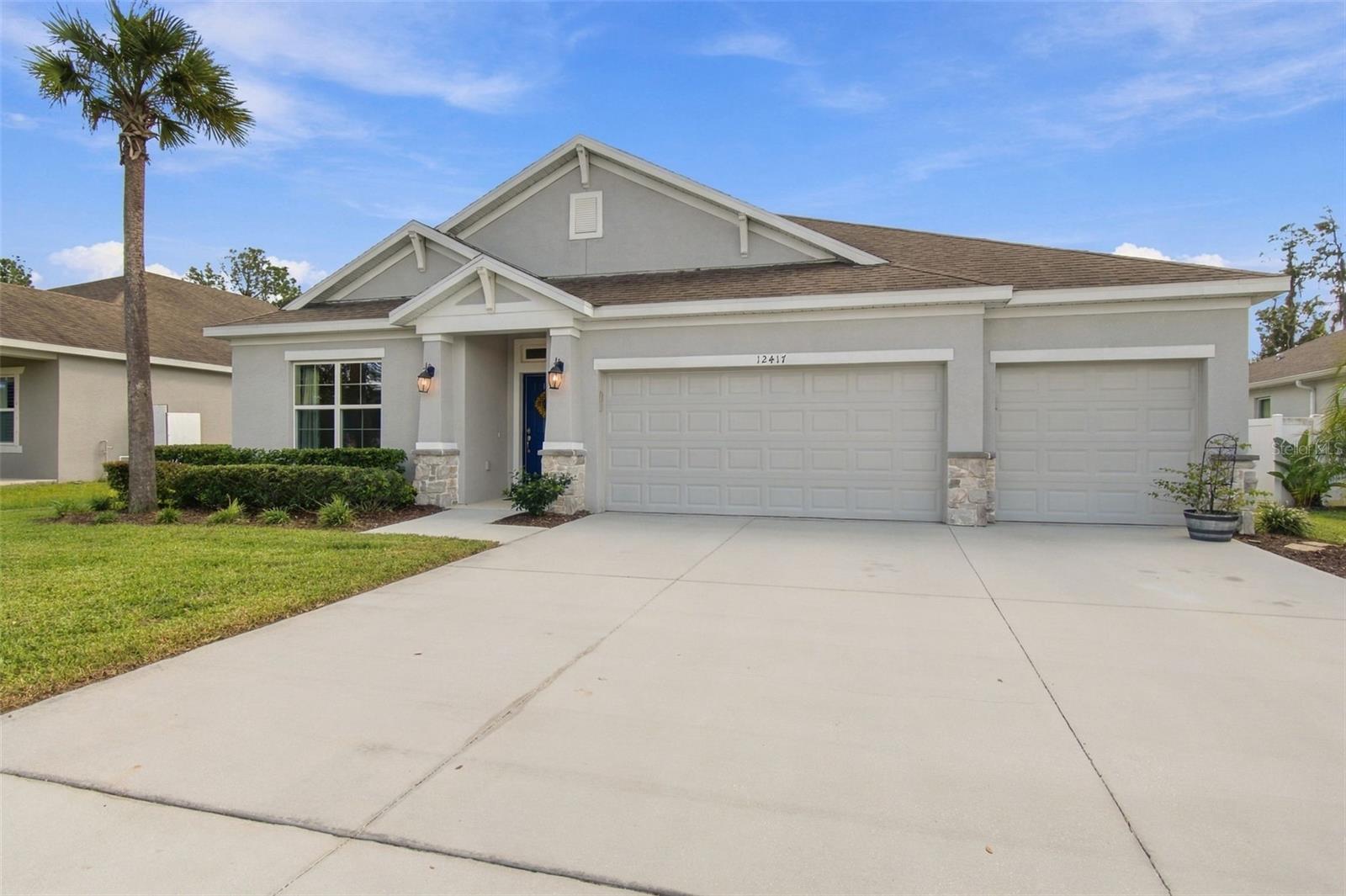 Front exterior - driveway and 3 car garage