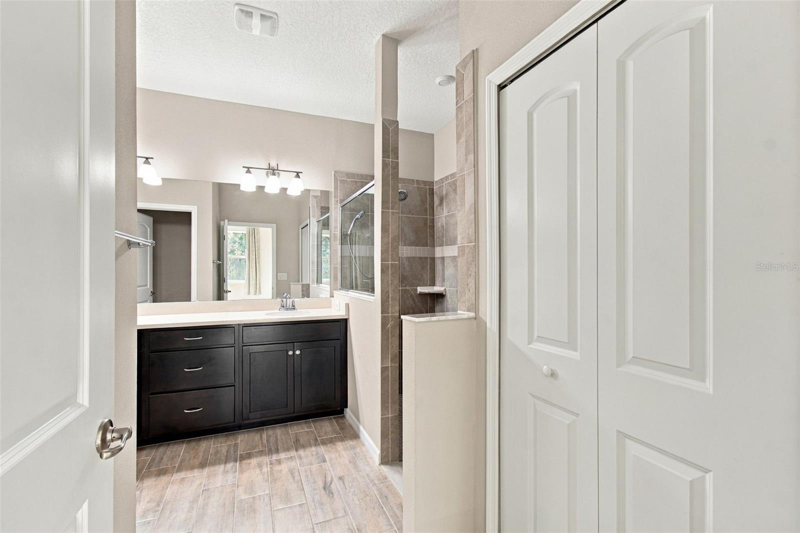 Entrance to en suite bathroom with linen closet to the right
