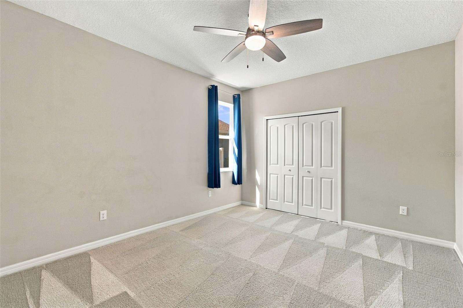 Larger bedroom with ceiling fan