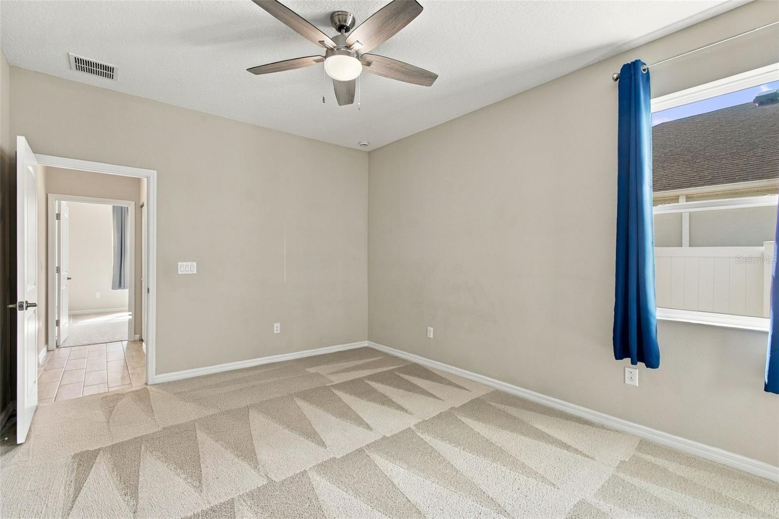 Larger bedroom with ceiling fan
