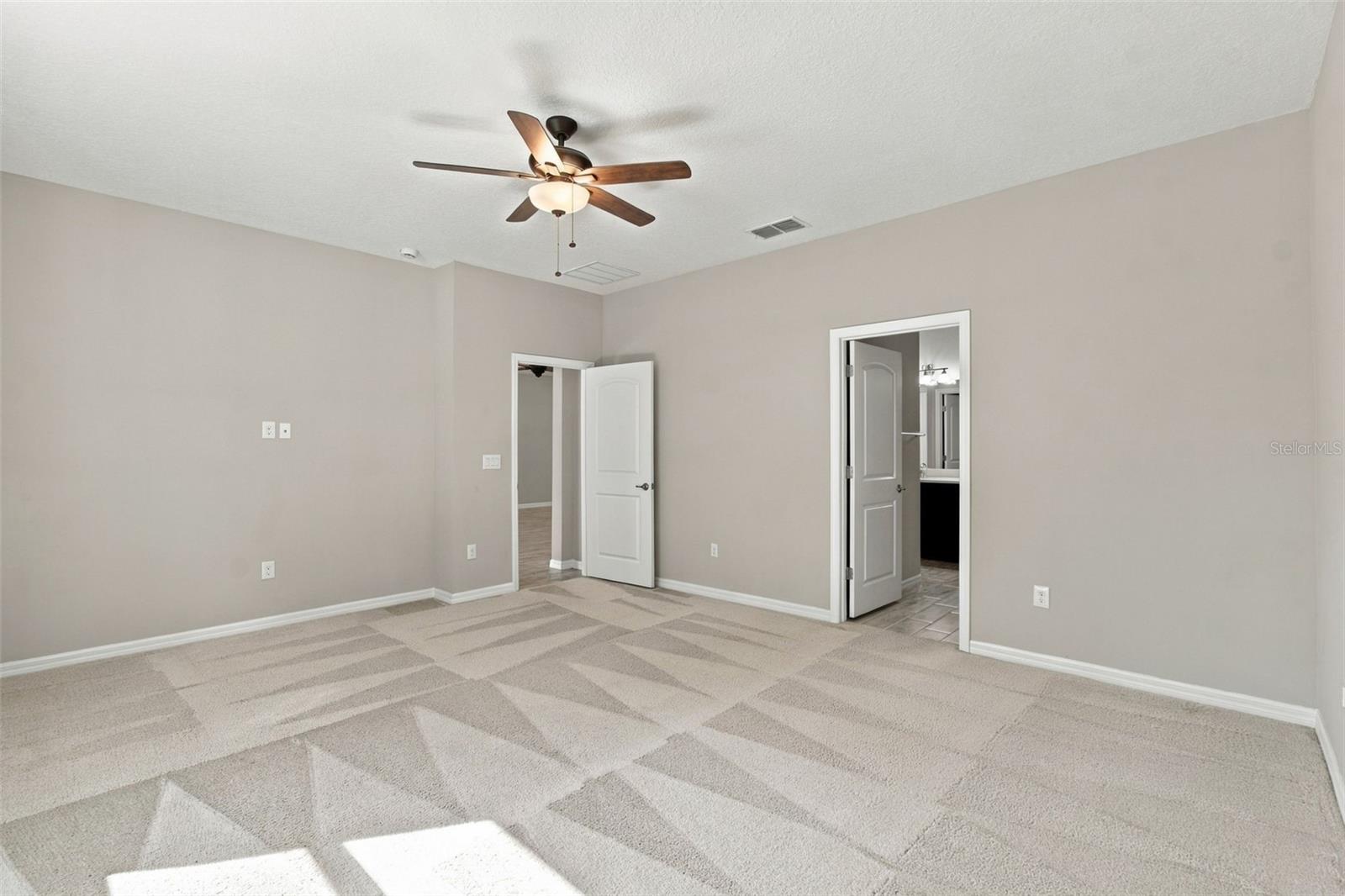 Primary bedroom with ceiling fan