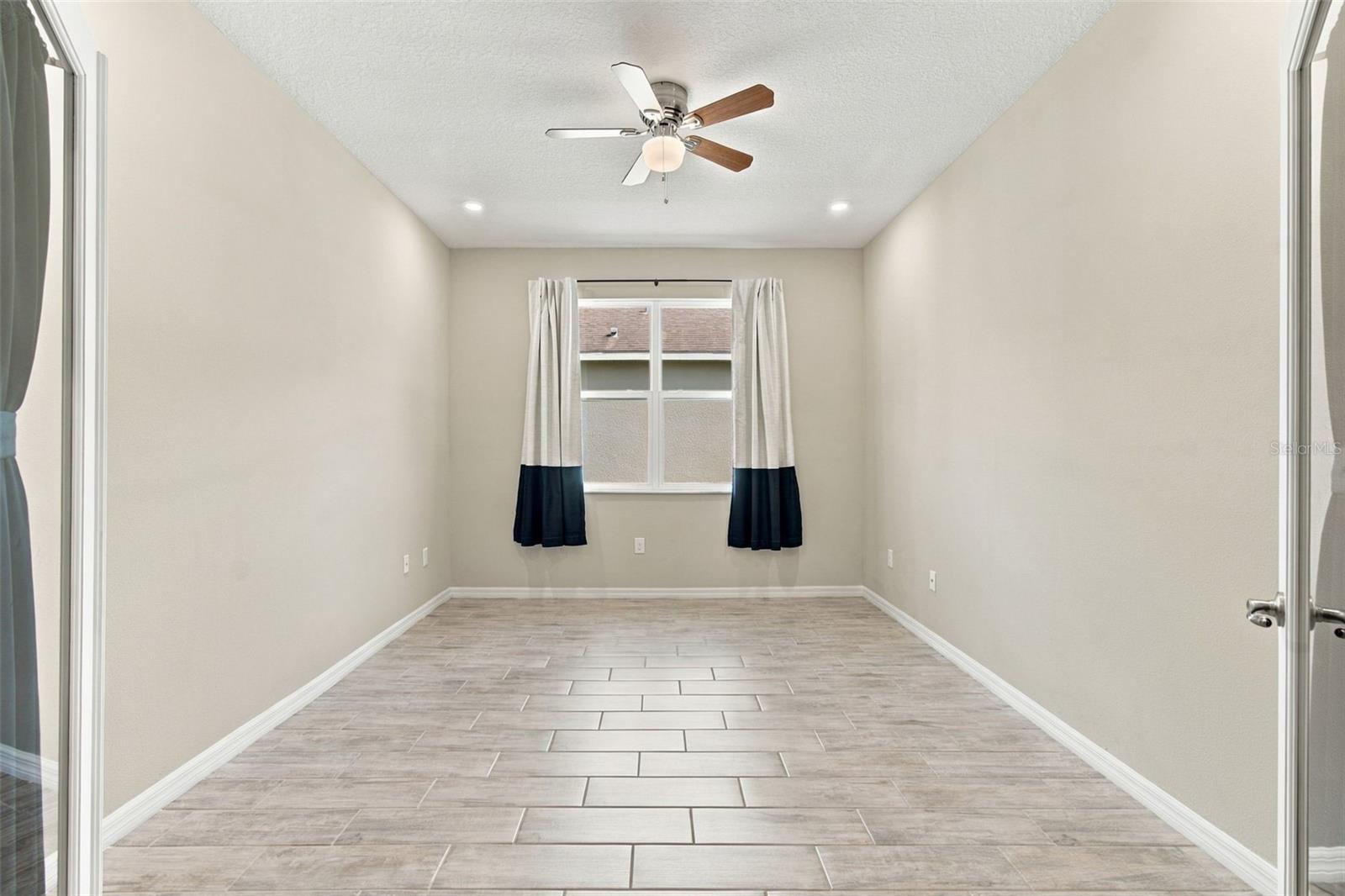 French doors open to private office with ceiling fan