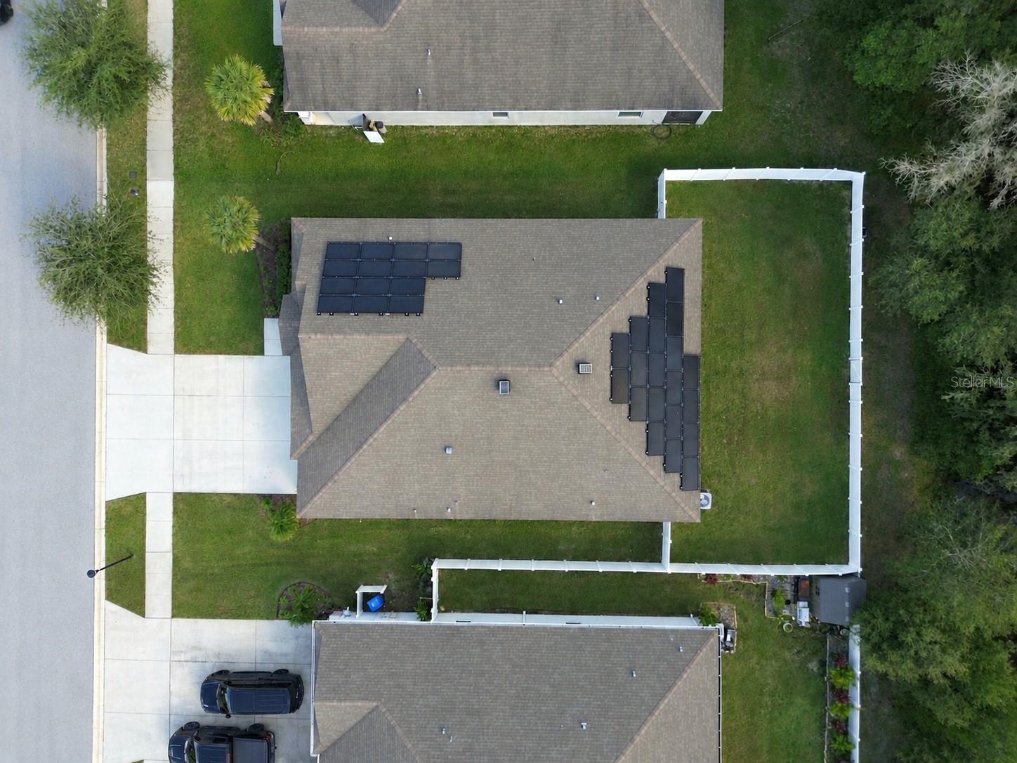 Lot overhead view, includes fully fenced backyard and solar panels