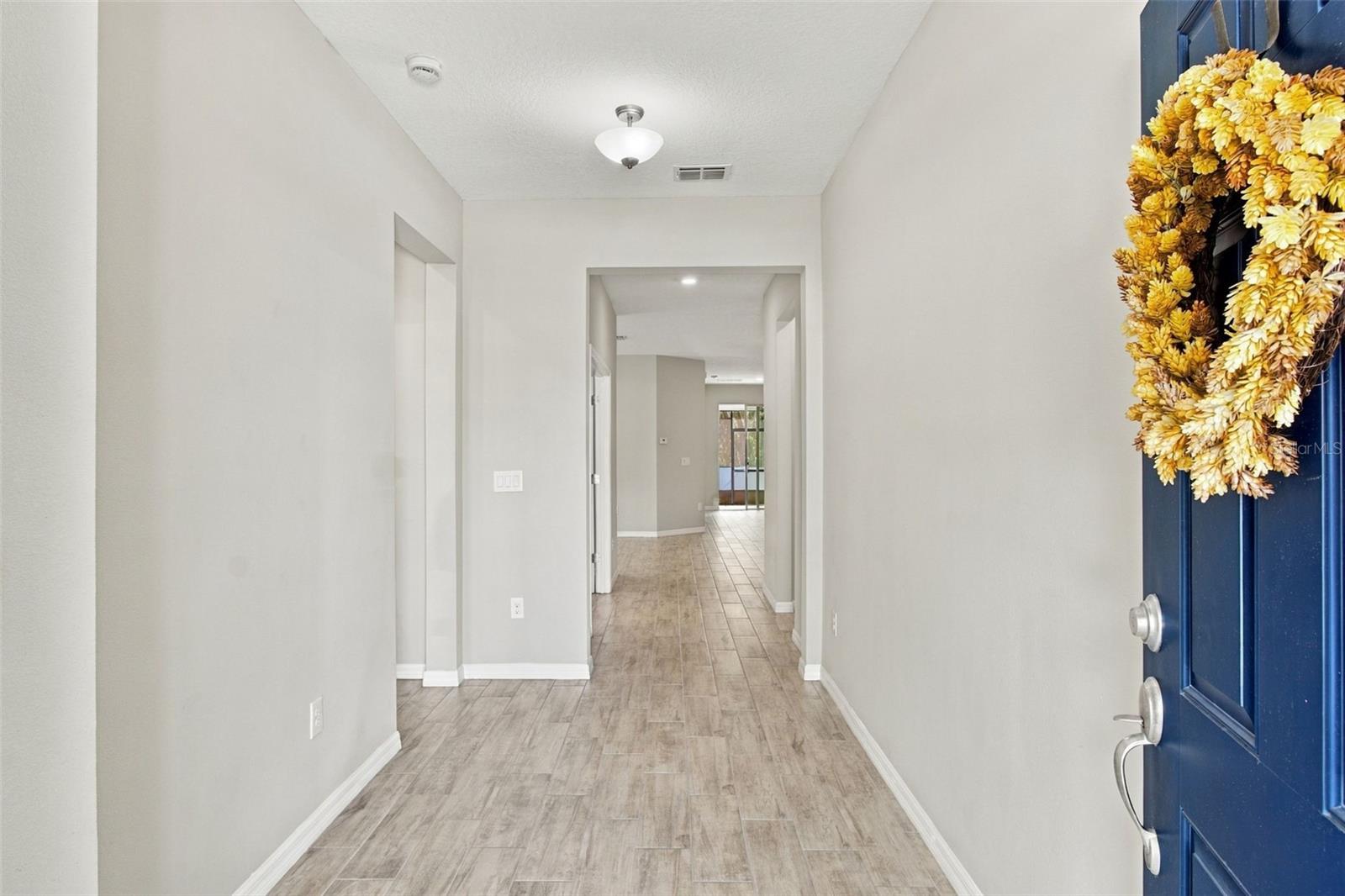 Foyer (guest suite entry to your left, followed by the office) - view extends to living room and patio in background