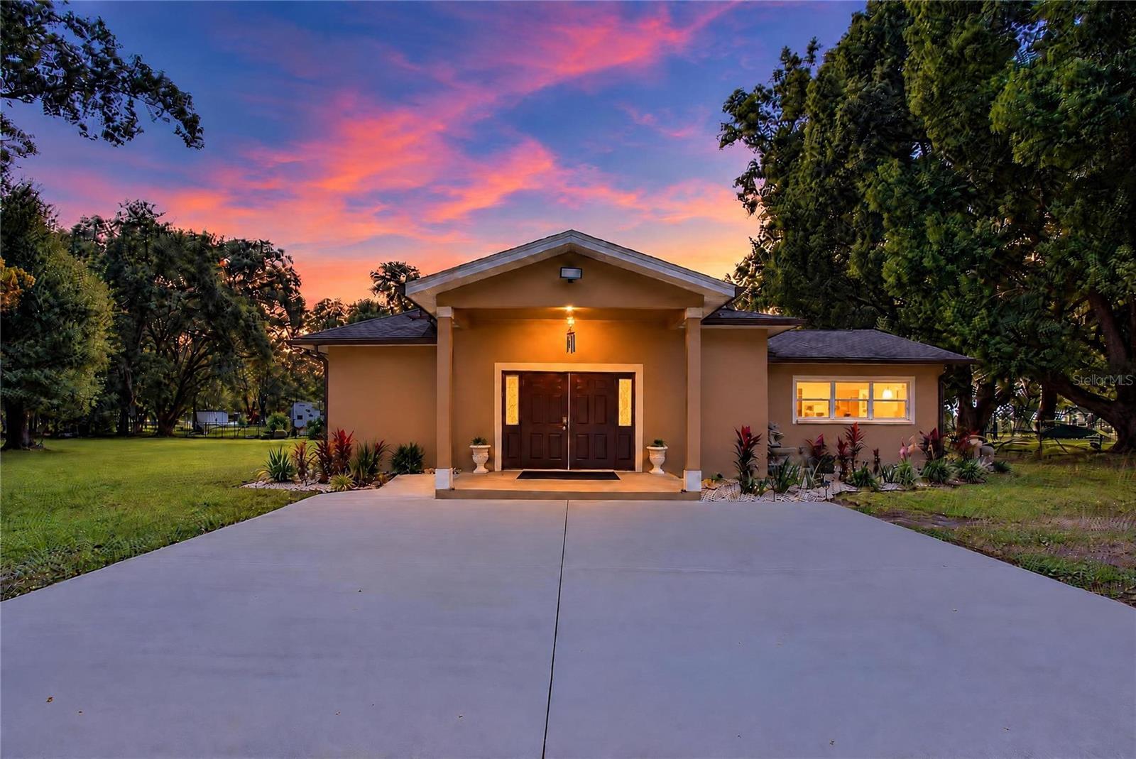 This photo has been digitally modified to illustrate how the front of the home would look without the existing carport. This photo has been digitally modified to illustrate how the front of the home would look without the existing carport.