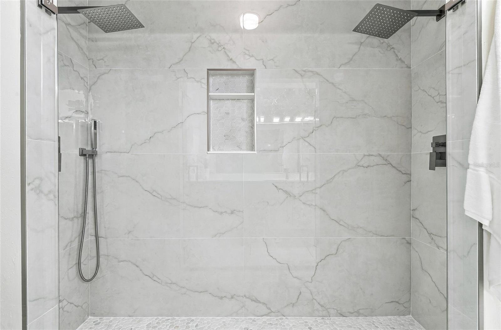 Dual rain shower heads in the primary bathroom.