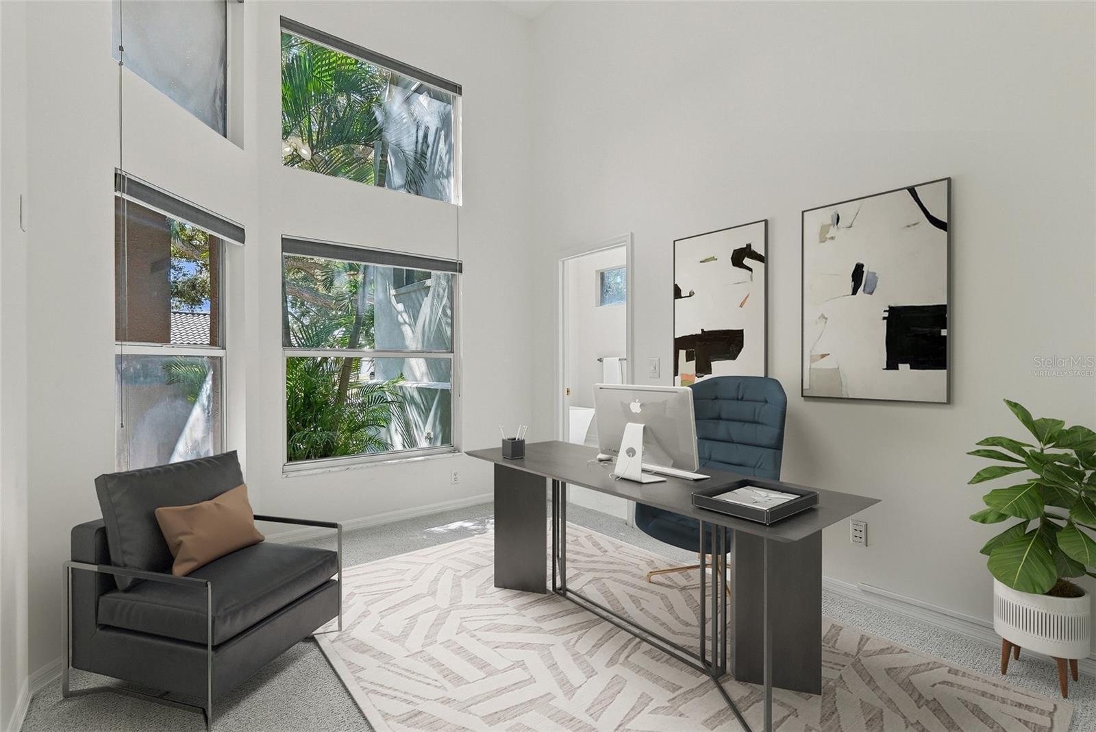Adjacent to the primary bedroom and bath lies a separate office. Virtually staged.