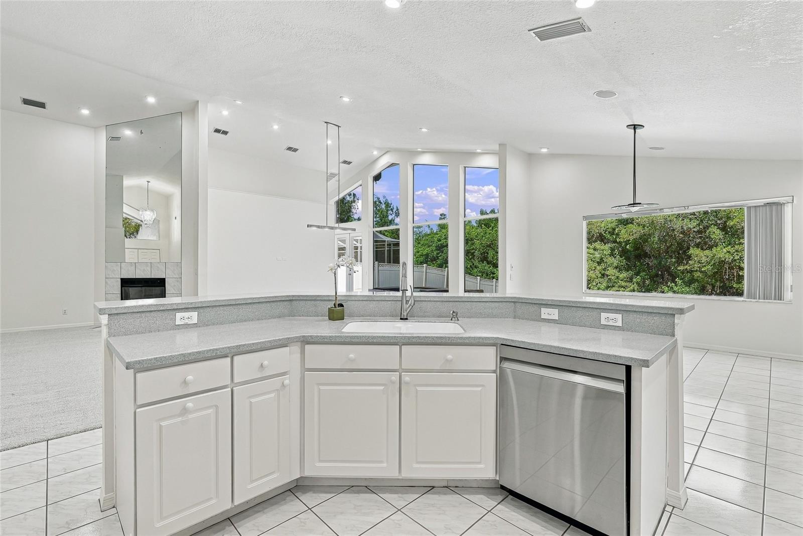 Open and spacious kitchen with breakfast bar for casual dining.