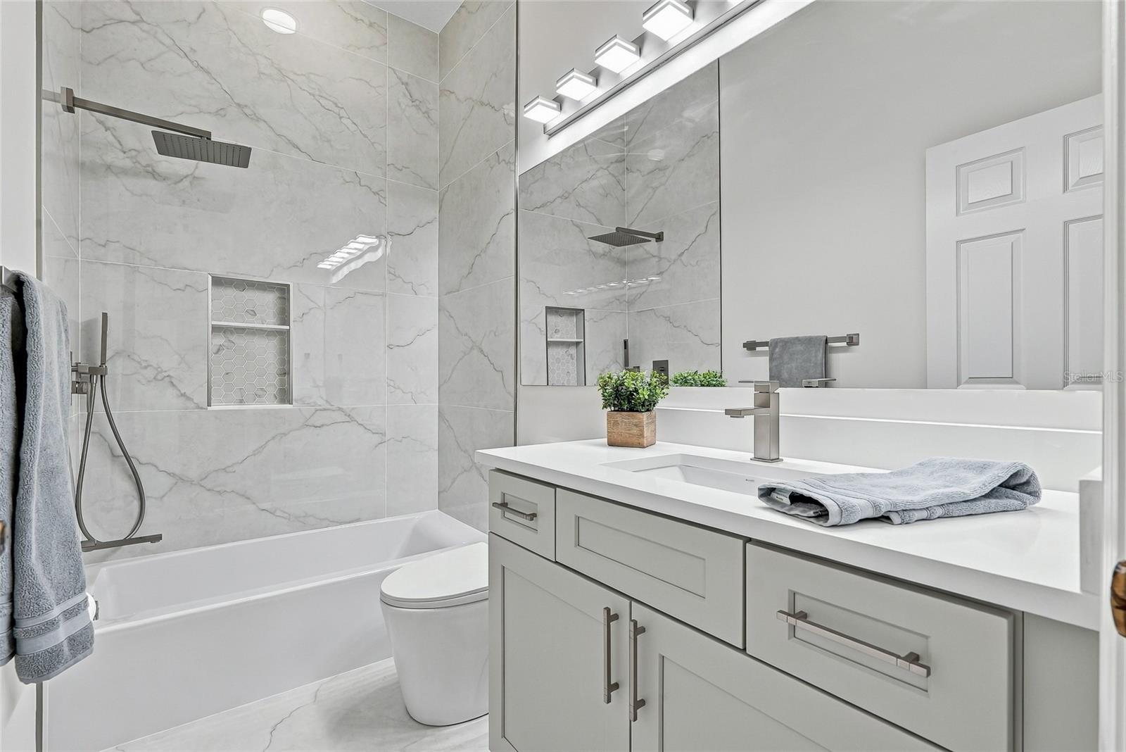 Full hall bath shared by bedrooms 3 and 4.
