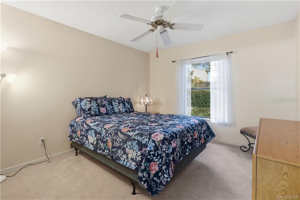 SWEET DREAMS! Comfortable GUEST BEDROOM offers neutral carpeting, CEILING FAN & a window overlooking the attractive outdoor greenery!
