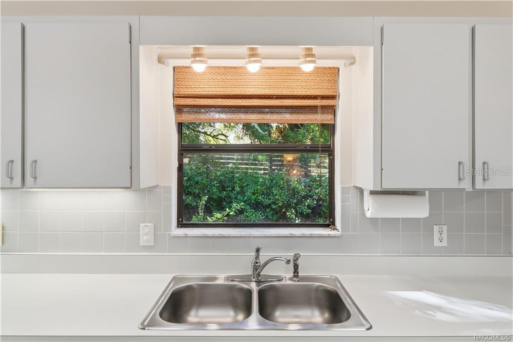 EVERYTHING IN ITS PLACE! Kitchen DOUBLE-BASIN STAINLESS STEEL SINK is perfectly positioned beneath a window overlooking the greenery!