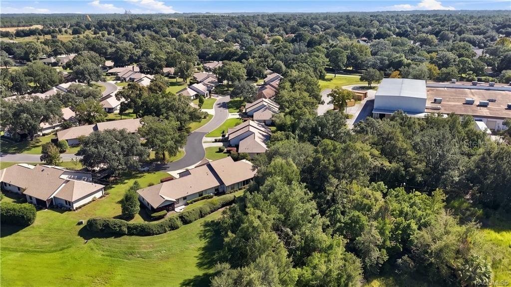 AERIAL VIEW OF SURROUNDING GREEN SPACEAn elevated view highlights the property's surrounding neighborhood, established landscaping, mature trees, and expansive nearby green space.