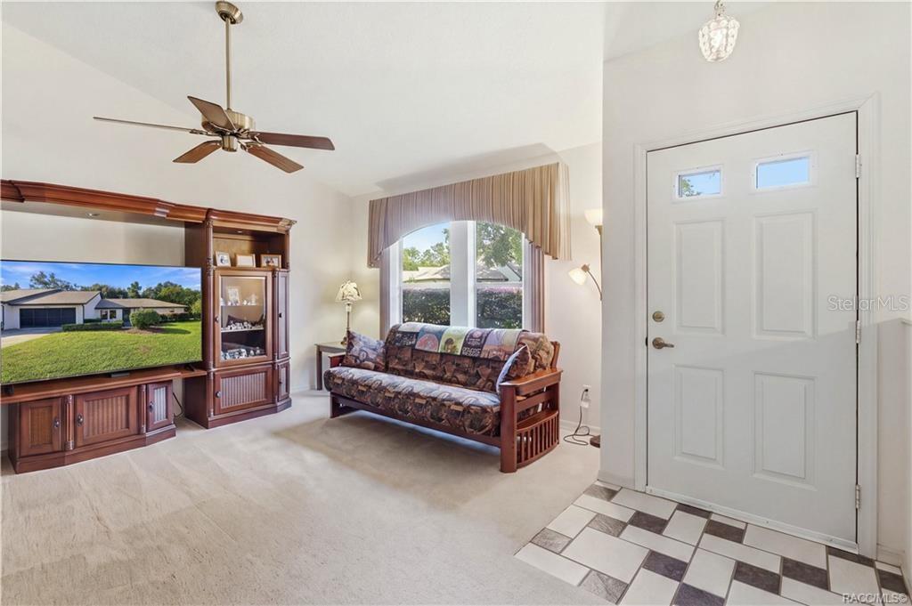 MAKE YOURSELF AT HOME! Bright & inviting LIVING ROOM w/VAULTED CEILINGS, CEILING FAN & large front window welcoming natural light!