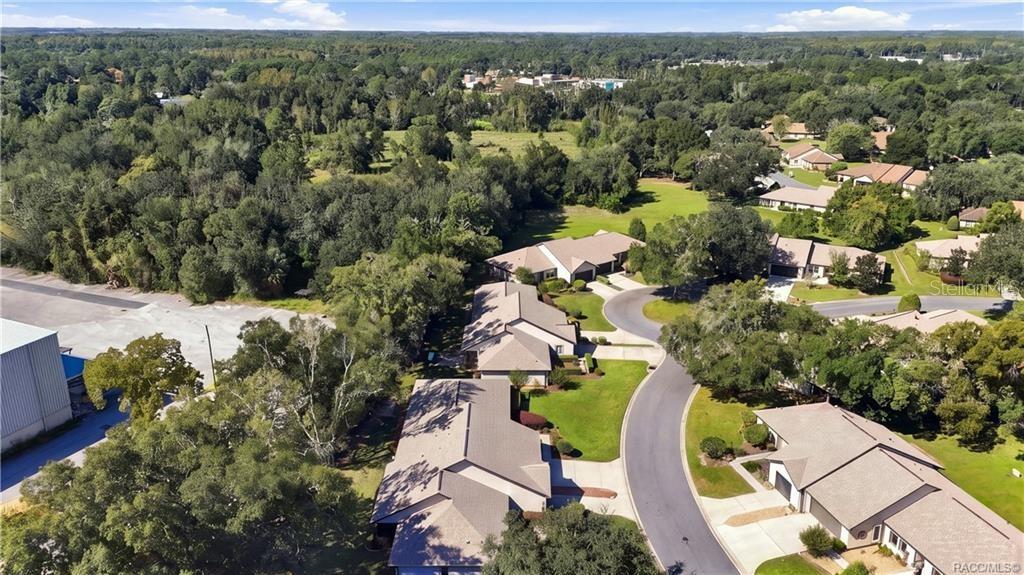AERIAL VIEW OF COMMUNITYEnjoy an aerial perspective of this established residential community, featuring winding streets, mature trees, attractive homes, and beautifully maintained green spaces.