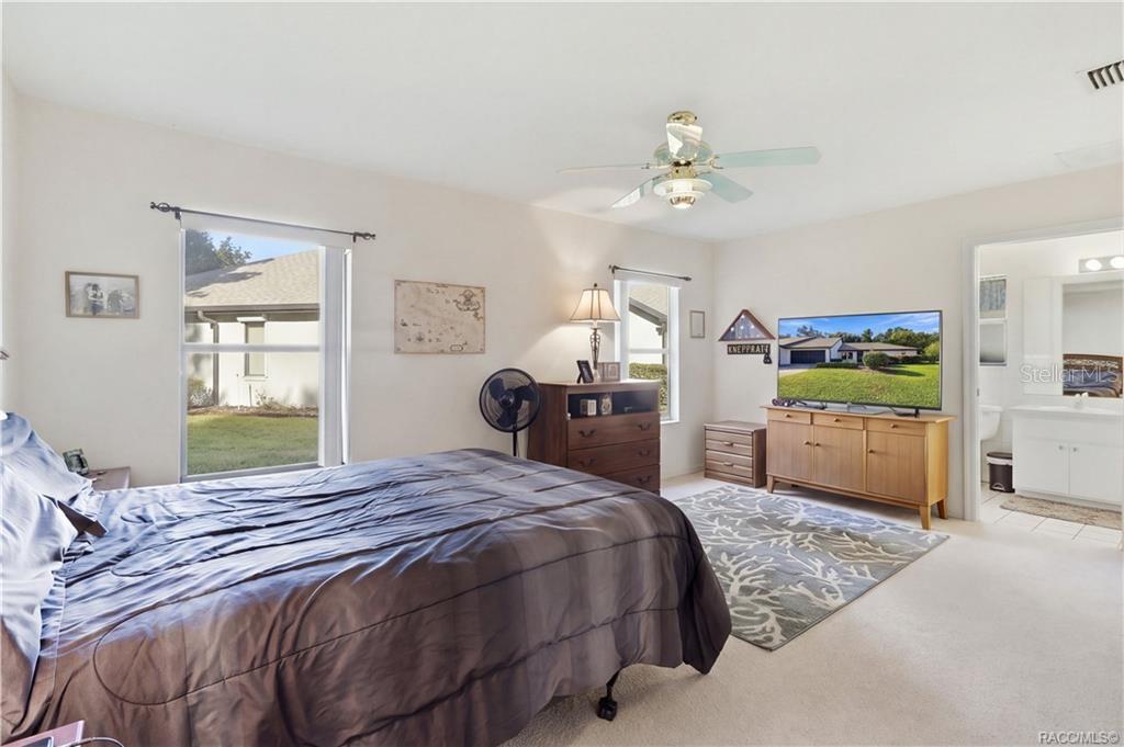 YOUR OWN PRIVATE RETREAT! Spacious PRIMARY BEDROOM offers comfortable surroundings, TWO WINDOWS, CEILING FAN & convenient access to the EN-SUITE BATH!