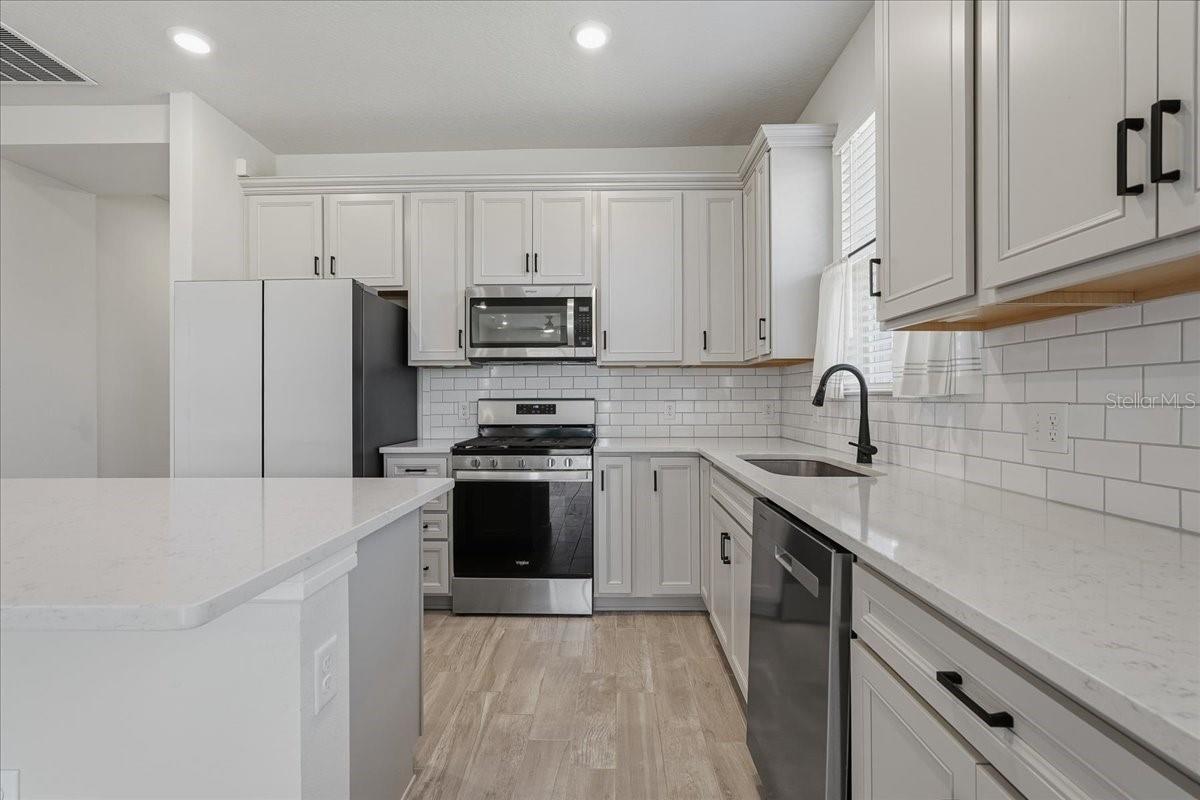 Kitchen - Tall Crown Molding on Cabinetry, 42" Uppers, Wastebasket pull out, Soft Close Drawers, Double Roll-Out Trays