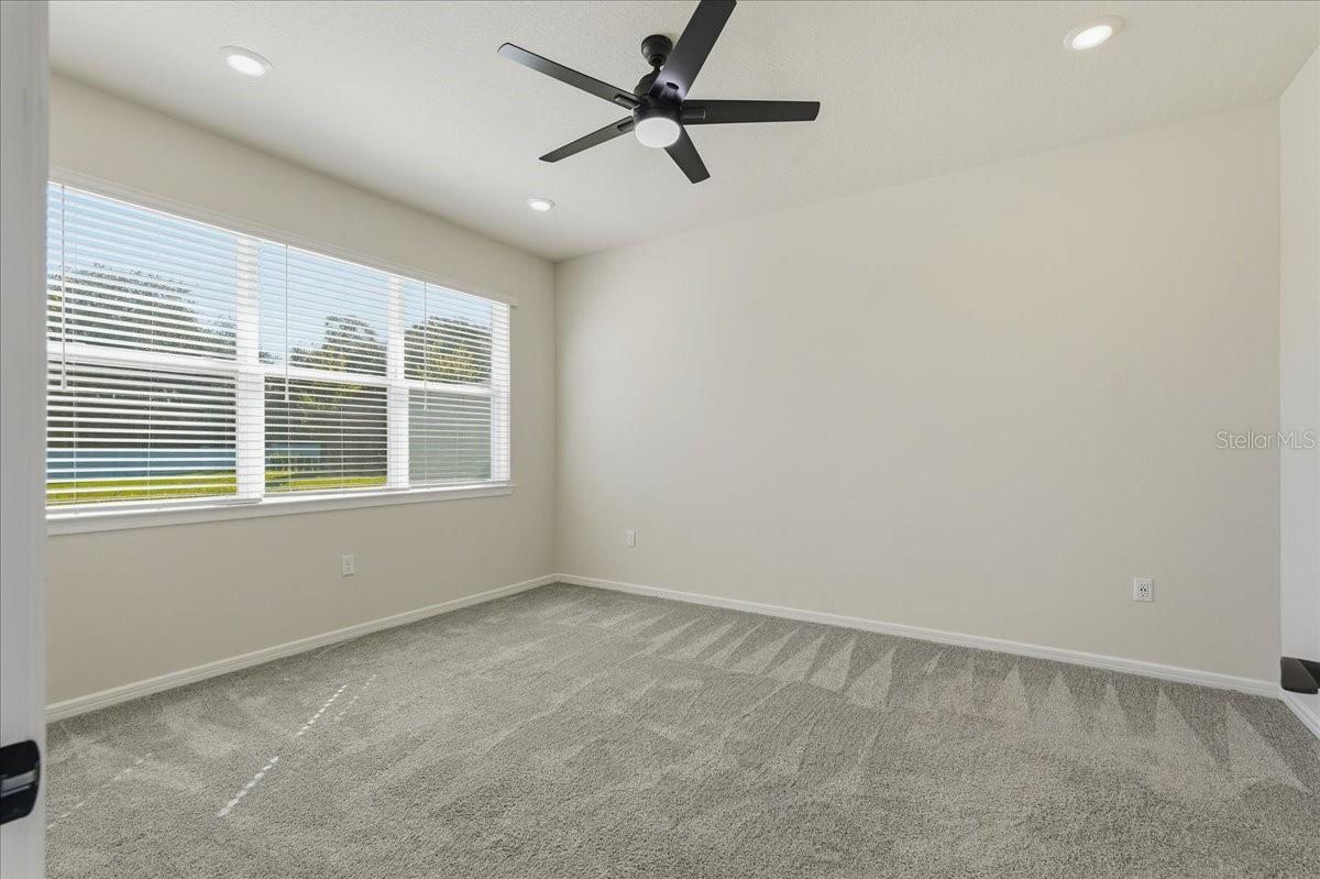 Primary Bedroom with Lighted Ceiling Fan and LED Downlights