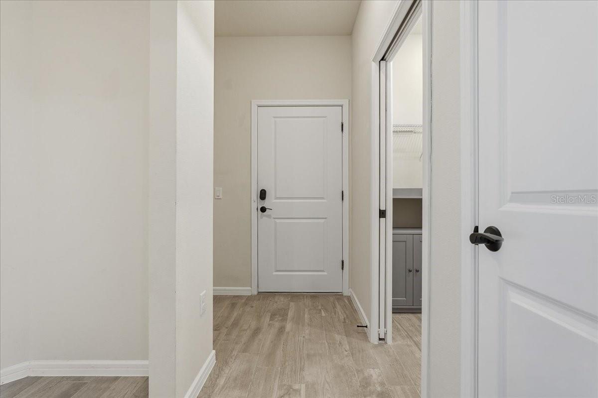 Garage Door Entry - Laundry Room on right with pocket door