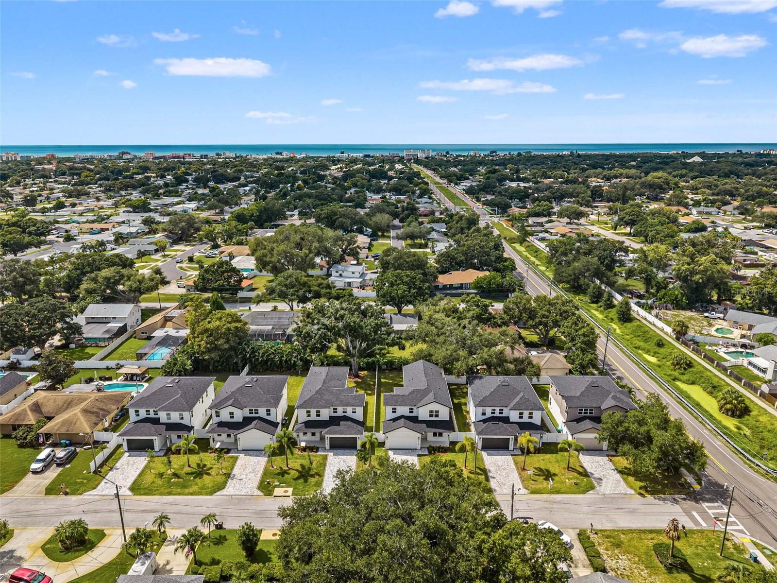 aerial view of all homes with the beach in the distance
