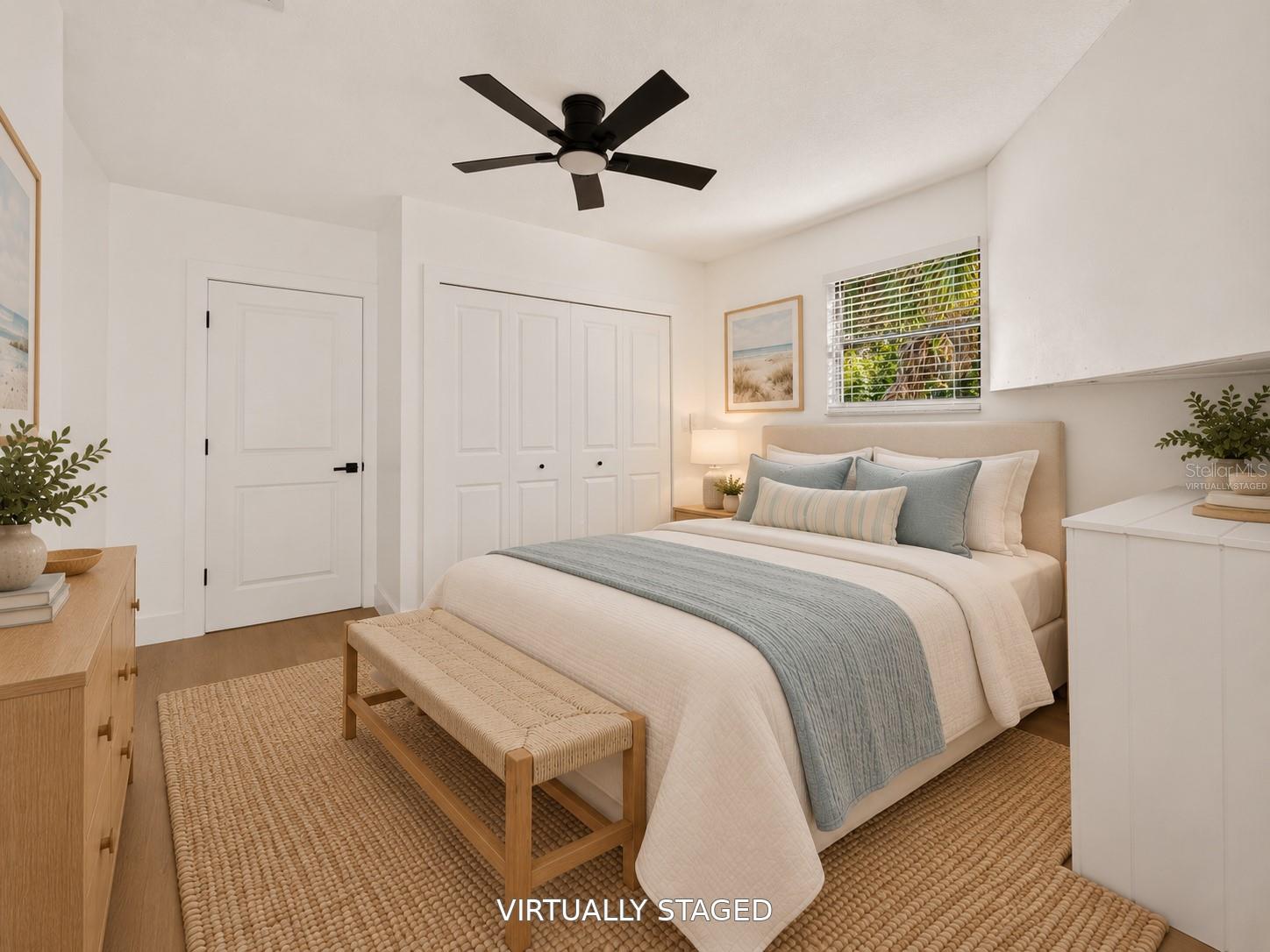 VIRTUALLY STAGED. Additional bedroom featuring a sleek black ceiling fan and updated flooring.
