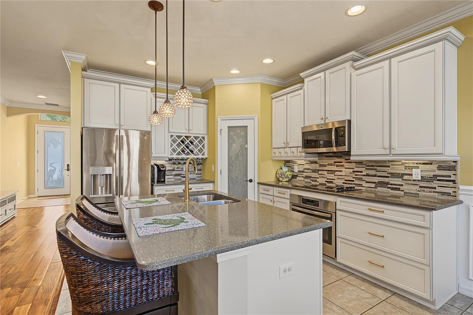 Glass backsplash offsets 42" cabinets with crown