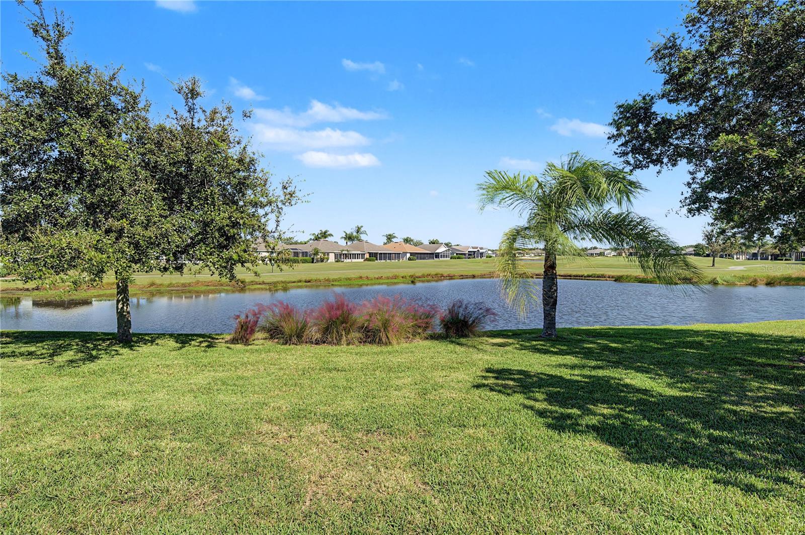 Deep backyard with water and golf course beyond!