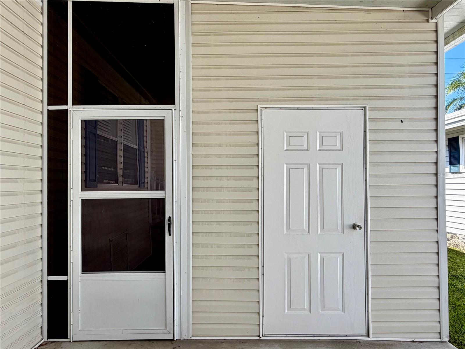Door on right is the storage shed, door on left leads to the Sunroom