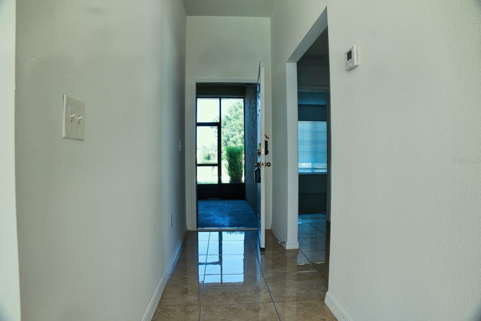 Inviting entrance hallway featuring a bright and welcoming transition into the home.