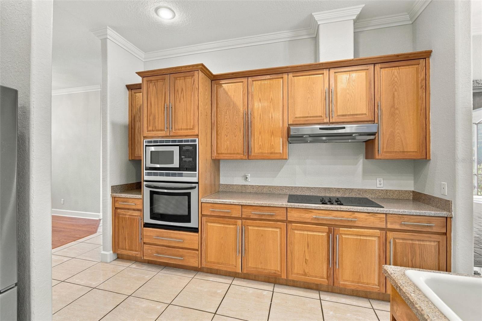 Kitchen with Built in Oven & Microwave. Cook Top with Vented Hood! Crown Molding just adorns this Kitchen's Real Wood Cabinetry!