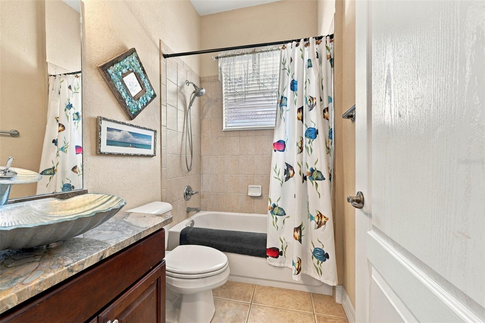 The bathroom is next to Bedroom #3 and beautifully updated in every detail.