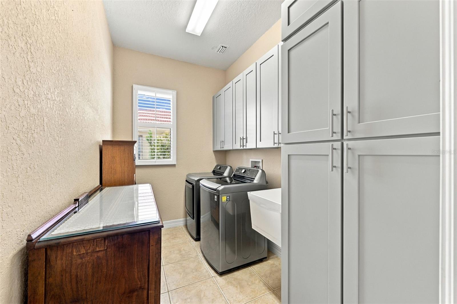 Laundry room is incredible with tons of storage and a utility sink.  Notice the overall size of the room!