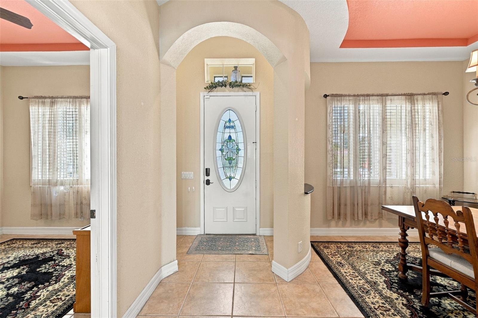 A unique feature is the curved entranceway that welcomes guests. This opens up the dining room to the right and the office to the left. A unique feature is the curved entranceway that welcomes guests. This opens up the dining room to the right and the office to the left.