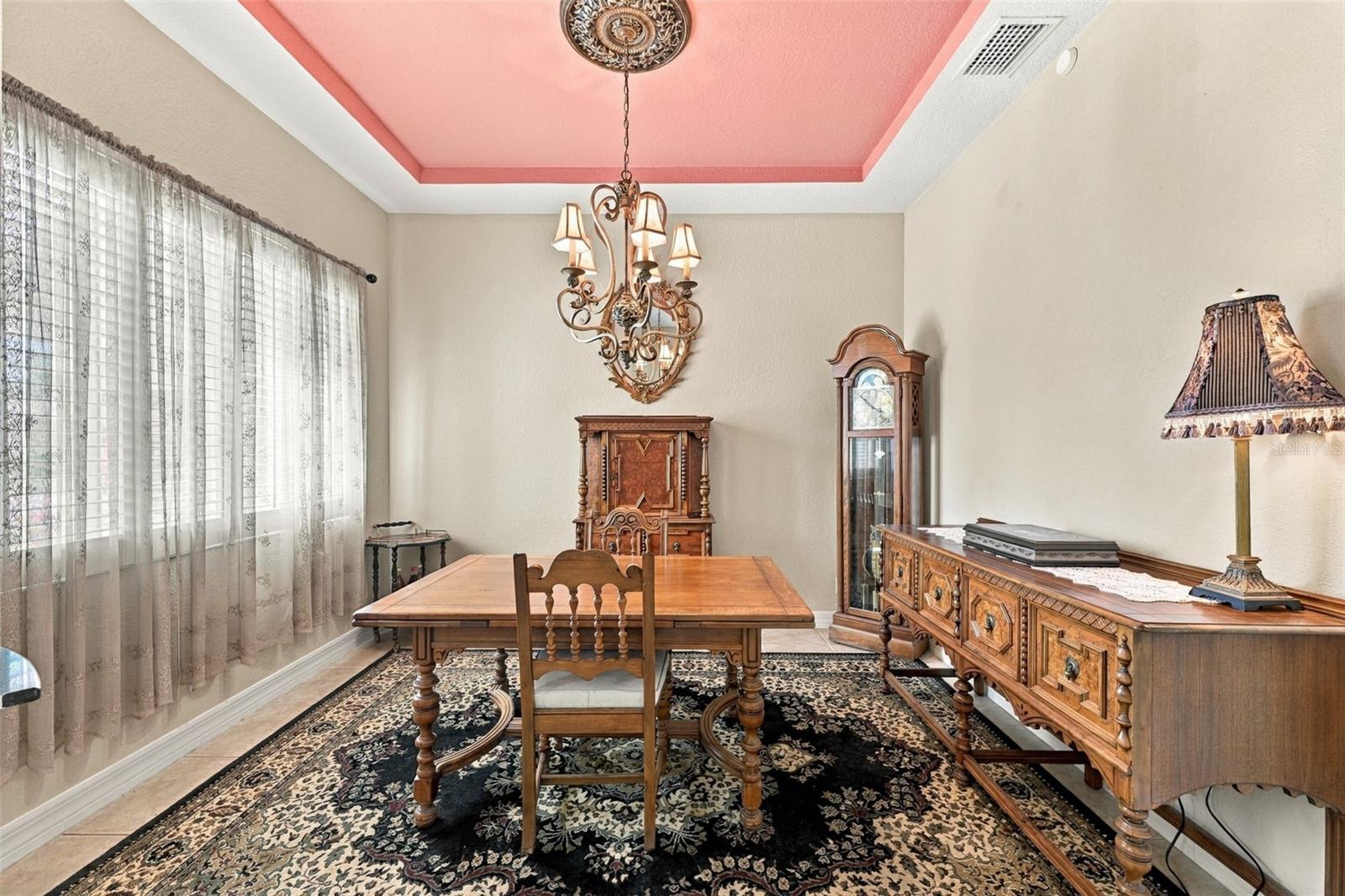 The dining room is spacious and perfect for a quiet dinner with friends and family, while also being open to the rest of the home.  Notice the tray ceiling.