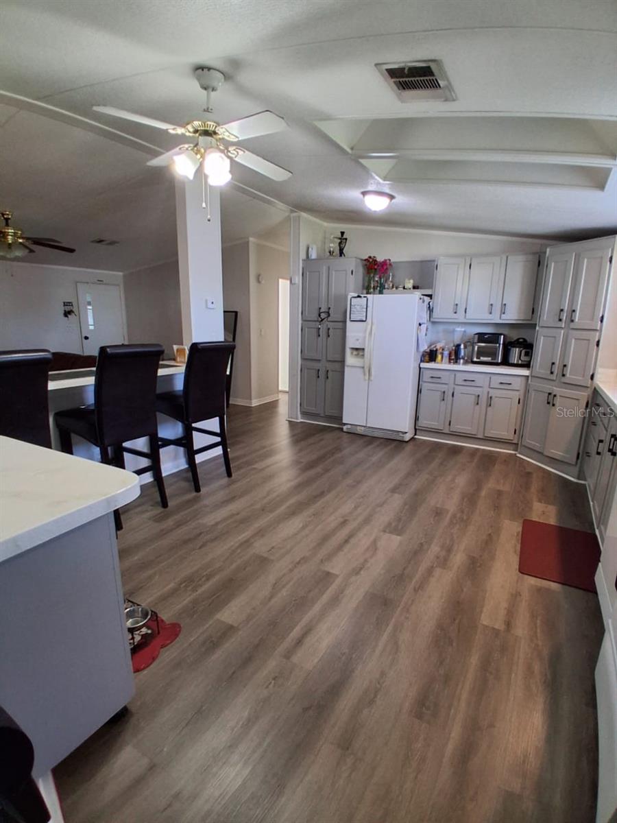 Shows kitchen bar area that looks into living room.  To the very left of this photoshows a moveable kitchen Island!  What convenience!To