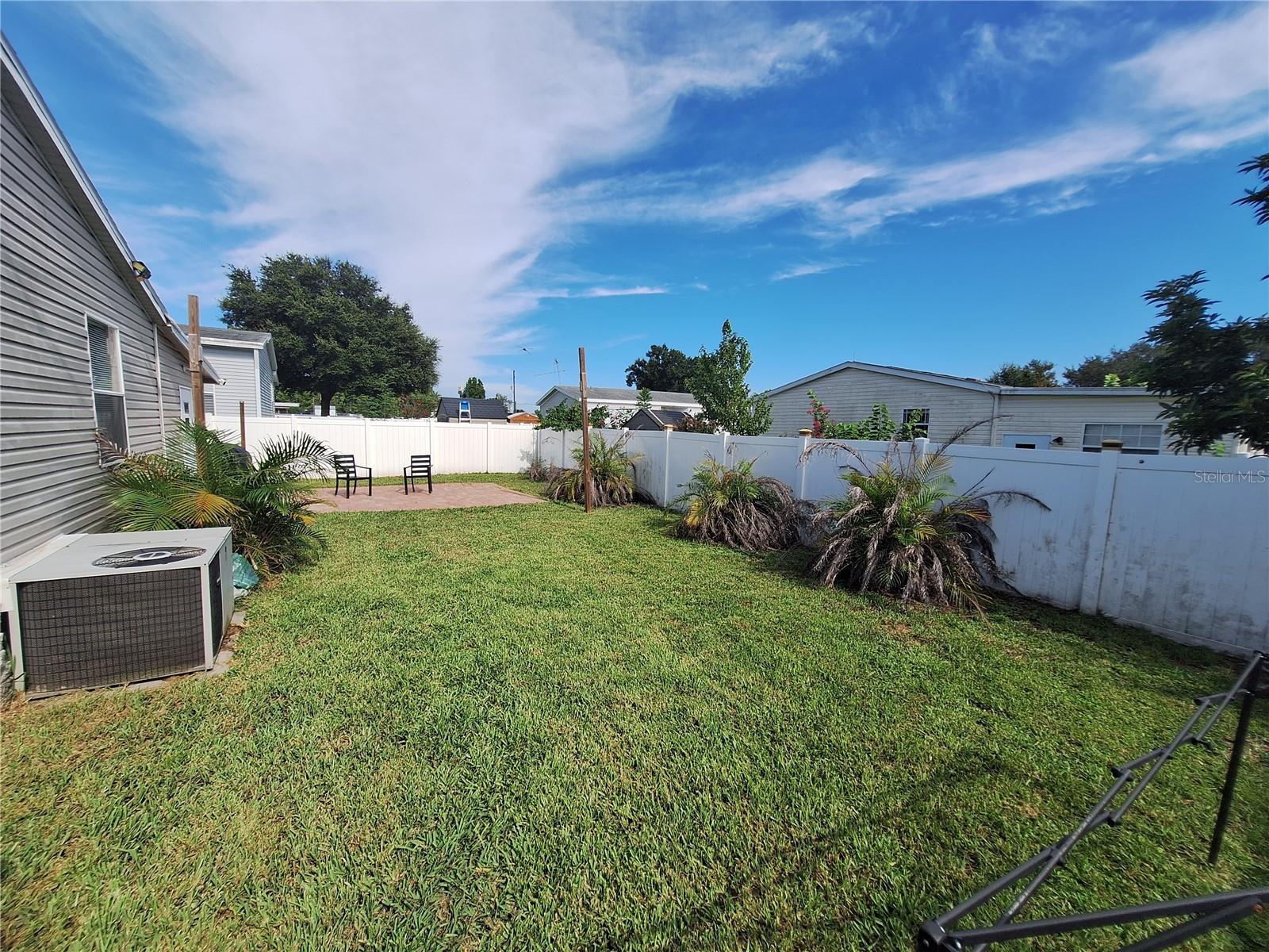 Fenced, landscaped backyard.