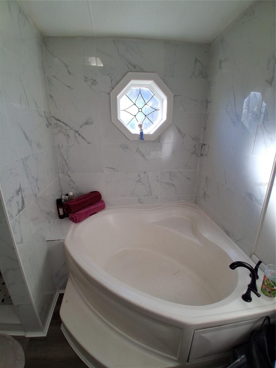 Primary private bath includes a soaker tub to soak the day away!  New faucet gives it a special look.